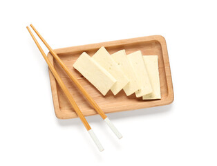Tray with slices of tasty tofu cheese and chopsticks isolated on white background