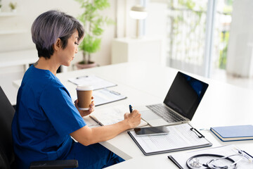 Woman doctor therapist writing in medical journal, sitting at desk in hospital office, working with documents, physician writing illness history, prescription in patient card.