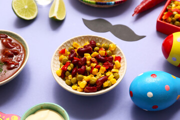 Traditional Mexican corn salad and mustache on lilac background. Cinco de Mayo (Fifth of May) celebration