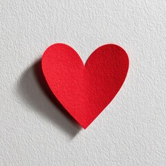 Obraz premium A vibrant red paper heart on a textured surface