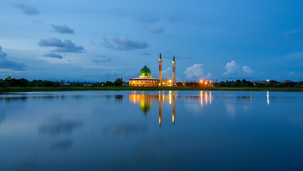 Mosque illuminated at dusk with reflection in a calm body of water Islamic building isolated on a transparent background
