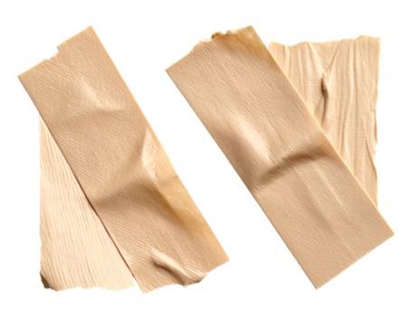 Two pieces of beige masking tape, wrinkled and slightly torn, laid diagonally on a black background