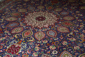 Detail of persian carpet macro: floral blue and red pattern texture
