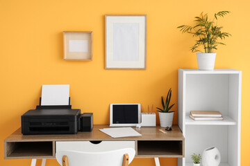 Workplace with modern printer and laptop in stylish home office