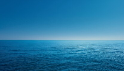 Obraz premium Serene blue ocean stretching under clear sky, calm water symbolizing tranquility, freedom and endless possibilities