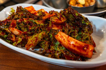 spicy seasoned vegetable salad with lettuce and onion