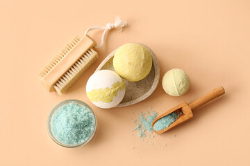 Composition with tray, bath bombs and scoop with sea salt on beige background, closeup