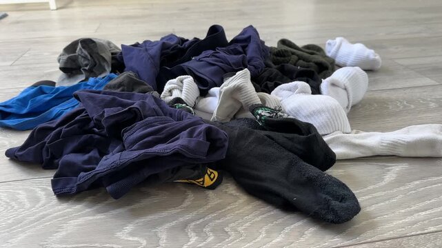 Pile of dirty pair of socks underwear boxer shorts on the bedroom floor laundry