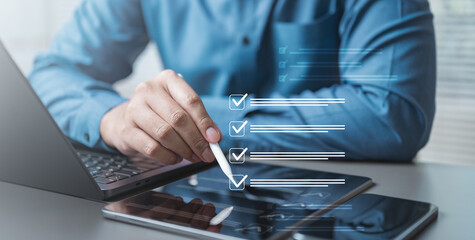 Business professional using a digital checklist on a tablet for task management, productivity, and project planning.