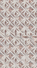Geometric pattern of repeating diamond shapes with floral accents in a textured design.