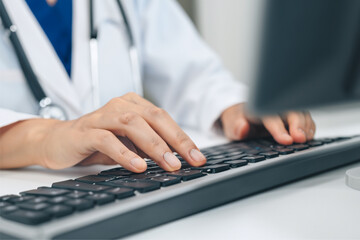 close up of male hands typing on keyboard
