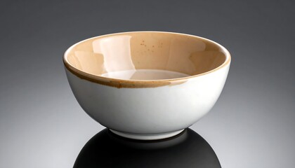 Empty round white bowl with a light brown, speckled, inner rim