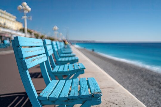 Row of bright blue chairs along a seaside promenade (1) - Powered by Adobe