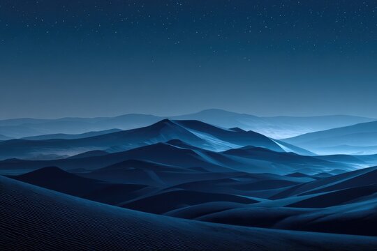 Dark blue dunes under a starlit sky