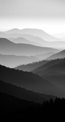 Misty mountain range, grayscale.  Layers of hazy peaks