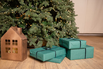 Christmas presents in green packaging under the tree