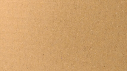 Background of brown kraft paper or cardboard texture. Abstract pattern of beige rough carton, old paper sheet.