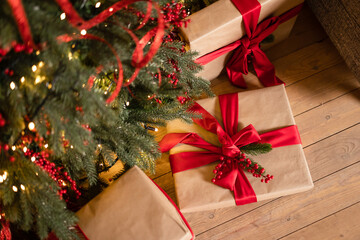 gifts with red ribbon under the Christmas tree