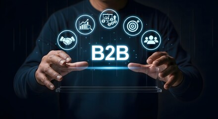 A person holding a b to b graphic with business icons floating above their hands in dark setting