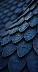 Close-up view of overlapping, dark-blue, leaf-shaped tiles
