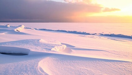 A snowy, frozen expanse under a soft, sunset-lit sky with cloud cover, casting long shadows across the textured snowdrifts and icy landscape
