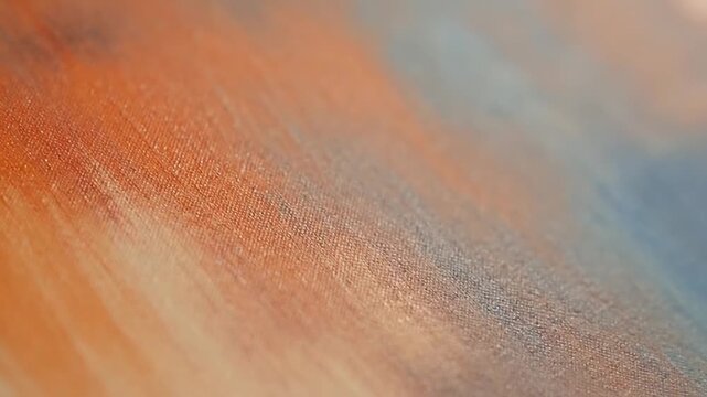 Abstract watercolor painting with warm orange and cool blue hues, creating a textured, artistic background