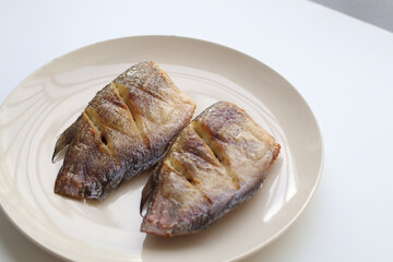Crispy fried gourami on a plate is a delicious Thai dish.