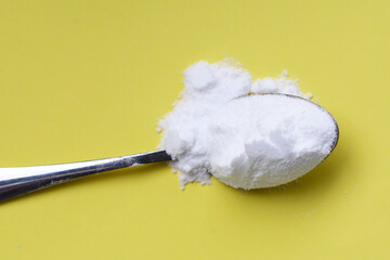 White creatine powder, used as a pre-workout supplement for gym and fitness.