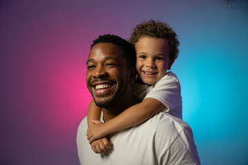 Obraz premium Happy father and son embracing with colorful background