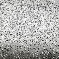 A myriad of raindrops adorns the glass surface, creating a unique texture