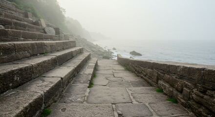 Obraz premium Stone steps leading to coastline in fog