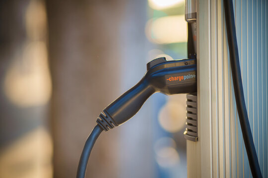 LOS ANGELES, CA - April 25, 2025: ChargePoint EV level 2 charger, closeup on EV power cord connector with plug plugged into the charging station.