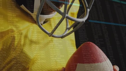 Camera panning across football-holding athlete starting data overlay and showing data analytics - Powered by Adobe