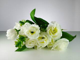 Picture of artificial white rose with white background. This photo can be used for wedding organizer advertising or other advertising that related to marriage