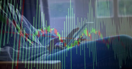 Mid adult woman tapping, swiping tablet by window tracking finance data with clear chart overlay - Powered by Adobe