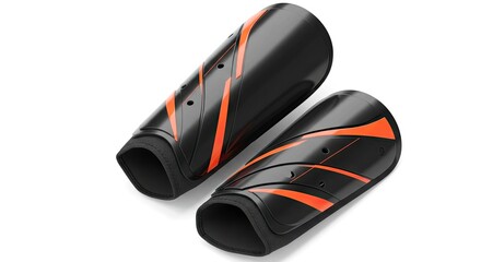 Black and orange shin guards two pieces laid flat on a white surface