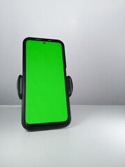 Picture of a smartphone showing green screen. This photo can be used for advertising 