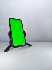 Picture of a smartphone showing green screen. This photo can be used for advertising 