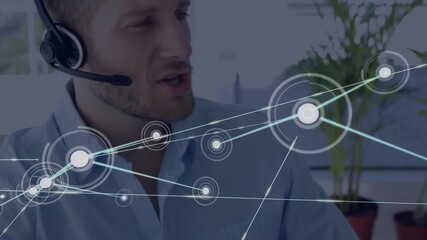 After typing man lifting headset and speaking while network graphics expanding for technology demo - Powered by Adobe