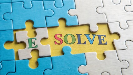 Fototapeta premium Problem Solving Concept: Blue and White Jigsaw Puzzle Pieces Forming the Word Solve on Yellow Background