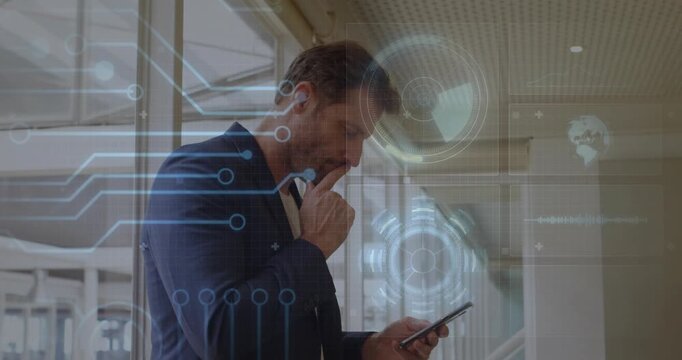 Mature male raising smartphone by windows tapping screen showing technology overlay analyzing data