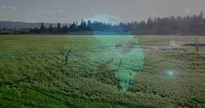 Drone view starting pivot arm rotating, spraying crops, holographic globe rising showing data nodes