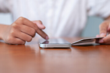 Mobile payment interaction office desk smartphone usage modern workspace close-up digital communication