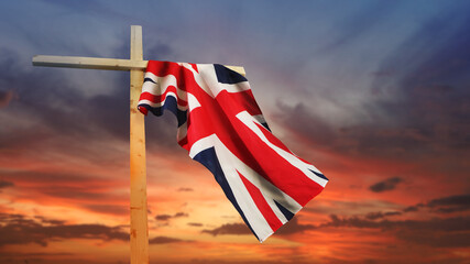 The British national flag on a religious cross against the sky. A concept for UK holidays