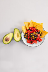 healthy nachos with corn black beans tomato avocado and corn chips