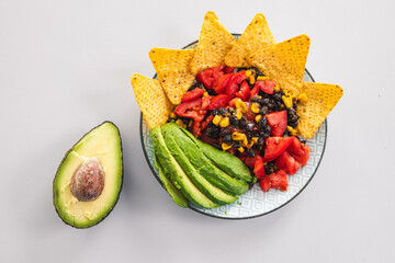 healthy nachos with corn black beans tomato avocado and corn chips