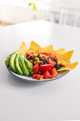 healthy nachos with corn black beans tomato avocado and corn chips