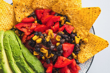 healthy nachos with corn black beans tomato avocado and corn chips