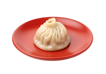 A single,  perfectly formed soup dumpling sits on a vibrant red plate, against a stark black backdrop.