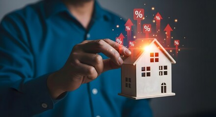 Person holding miniature house with percentage increase arrows floating above it on dark background